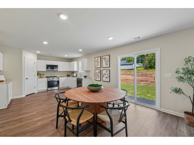 A kitchen with a dining table.