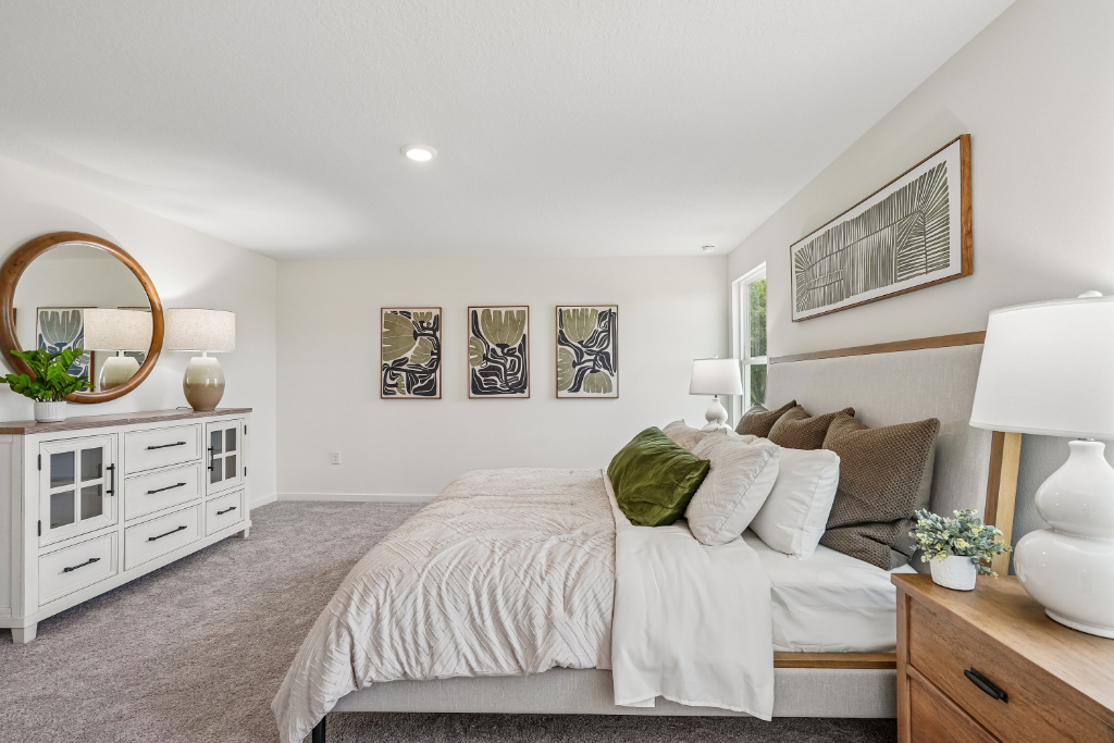 A bedroom with a bed and lamps.