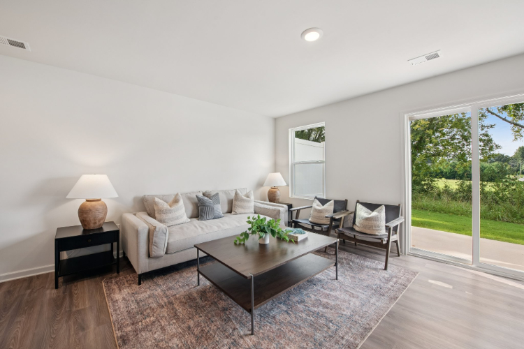 A living room with a large glass door.