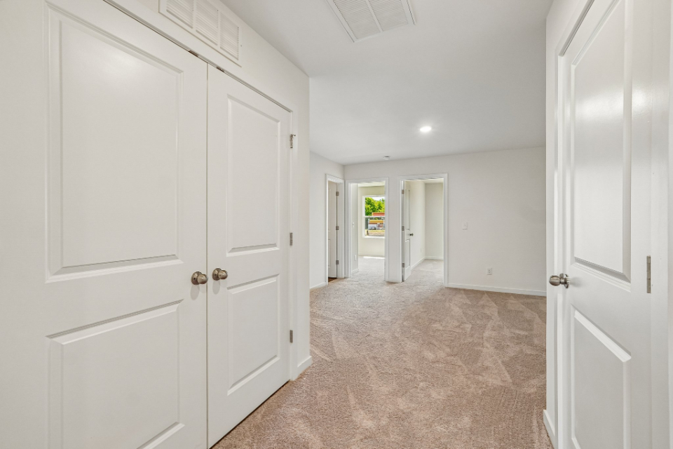 A hallway with white doors.