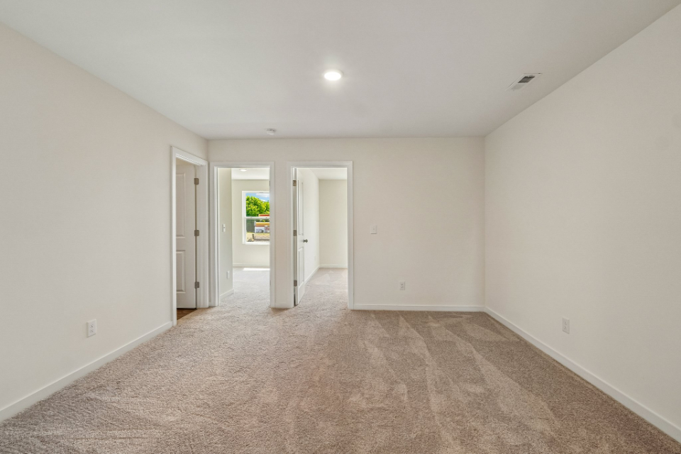 A hallway with white walls.