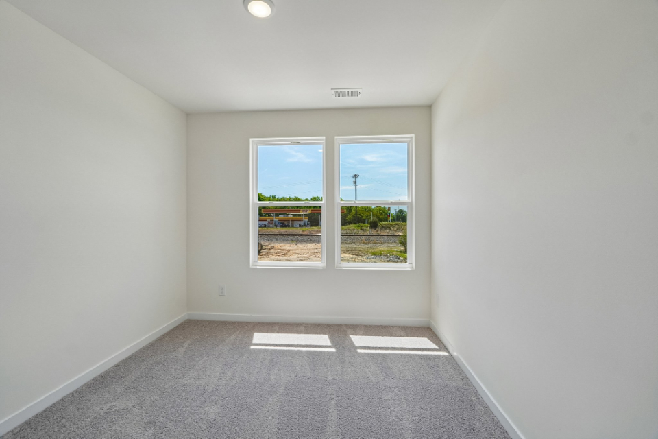 A room with a window and a tile floor.
