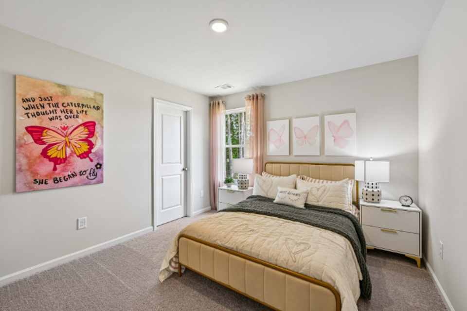 A bedroom with a bed and a lamp.