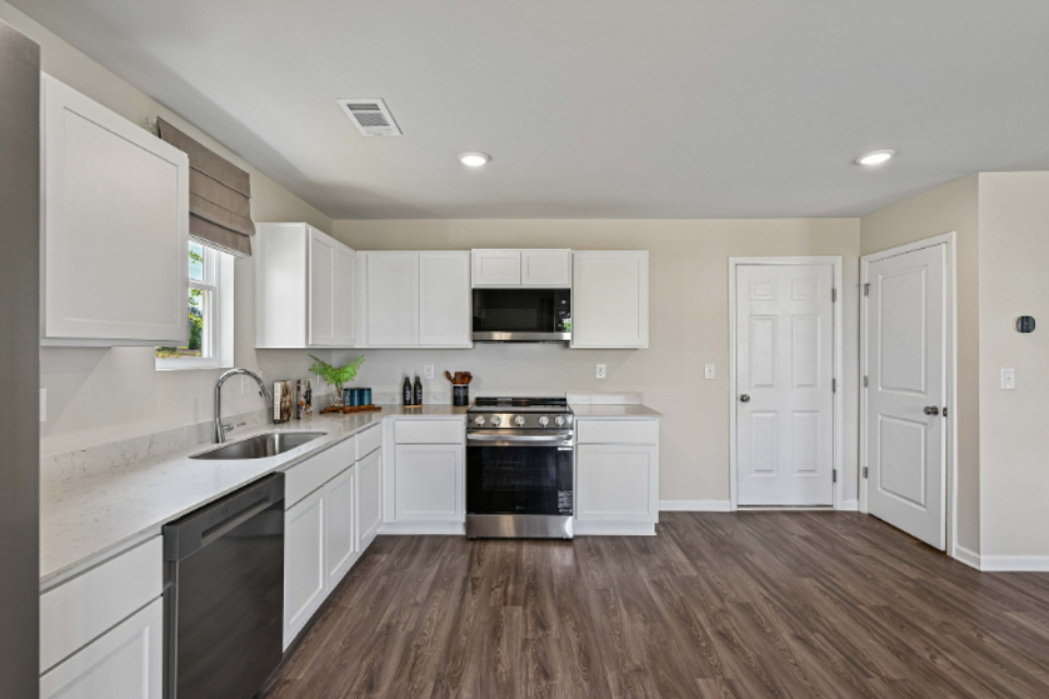 A kitchen with white cabinets.