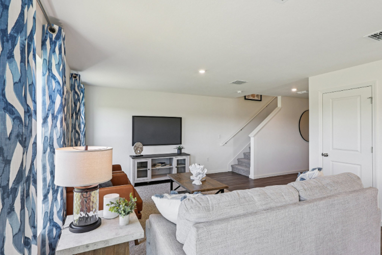 A living room with a couch and a tv.