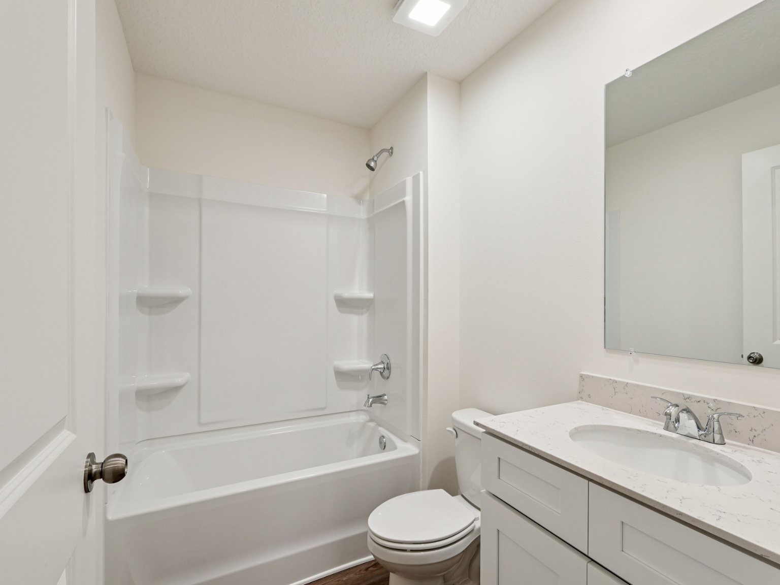A bathroom with a tub sink and toilet.