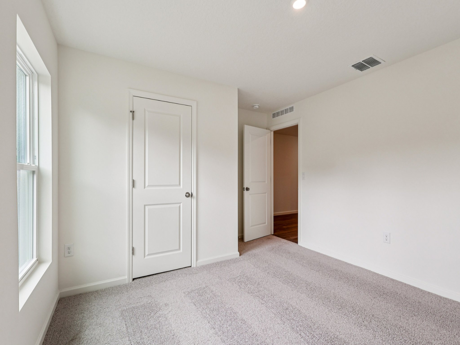 A hallway with white doors.