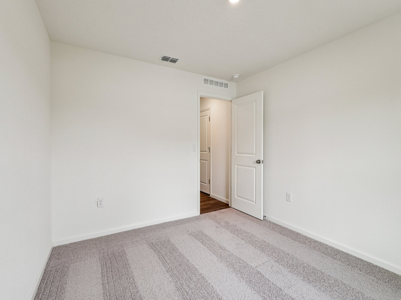 A hallway with white doors.