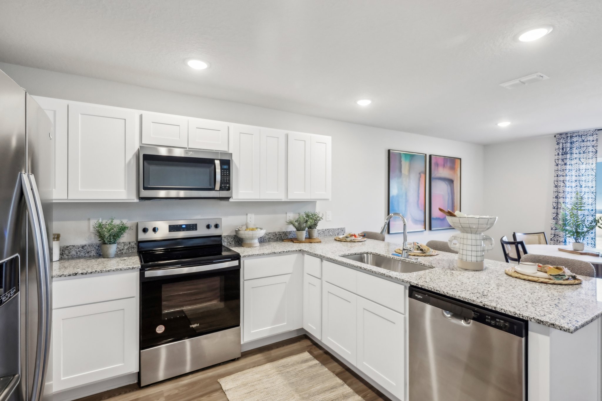 A kitchen with white cabinets.