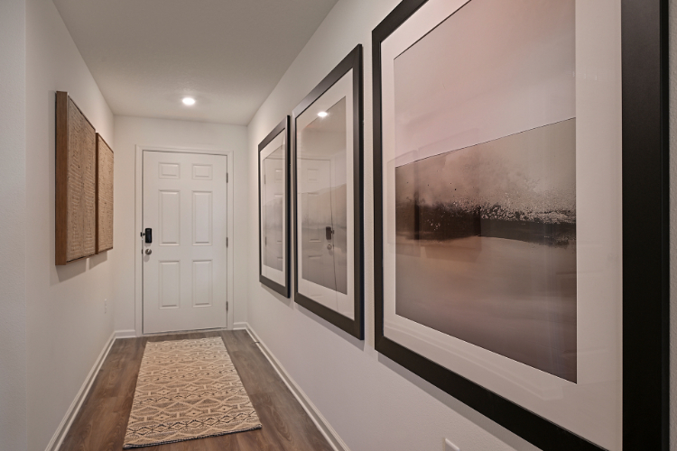 A room with a glass wall and a white door.
