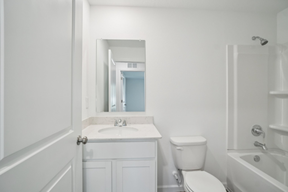 A bathroom with a sink toilet and bathtub.