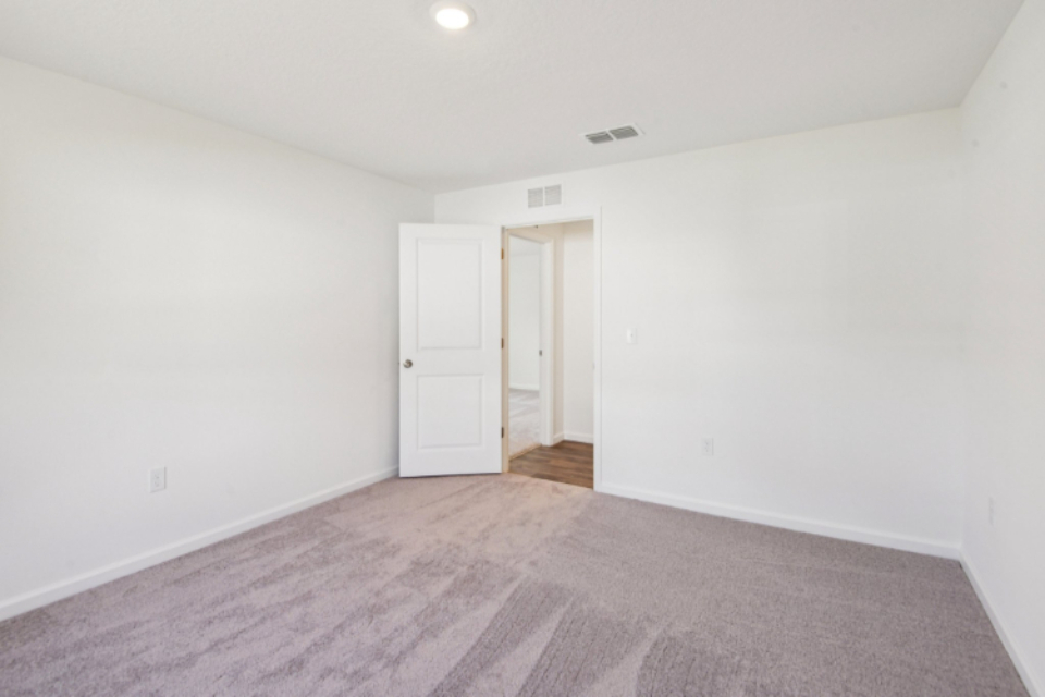 A hallway with white doors.