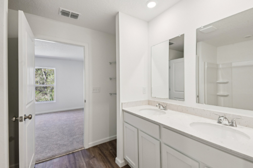 A bathroom with a large mirror.