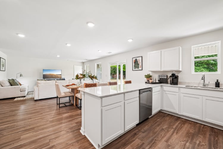 A kitchen with white cabinets.