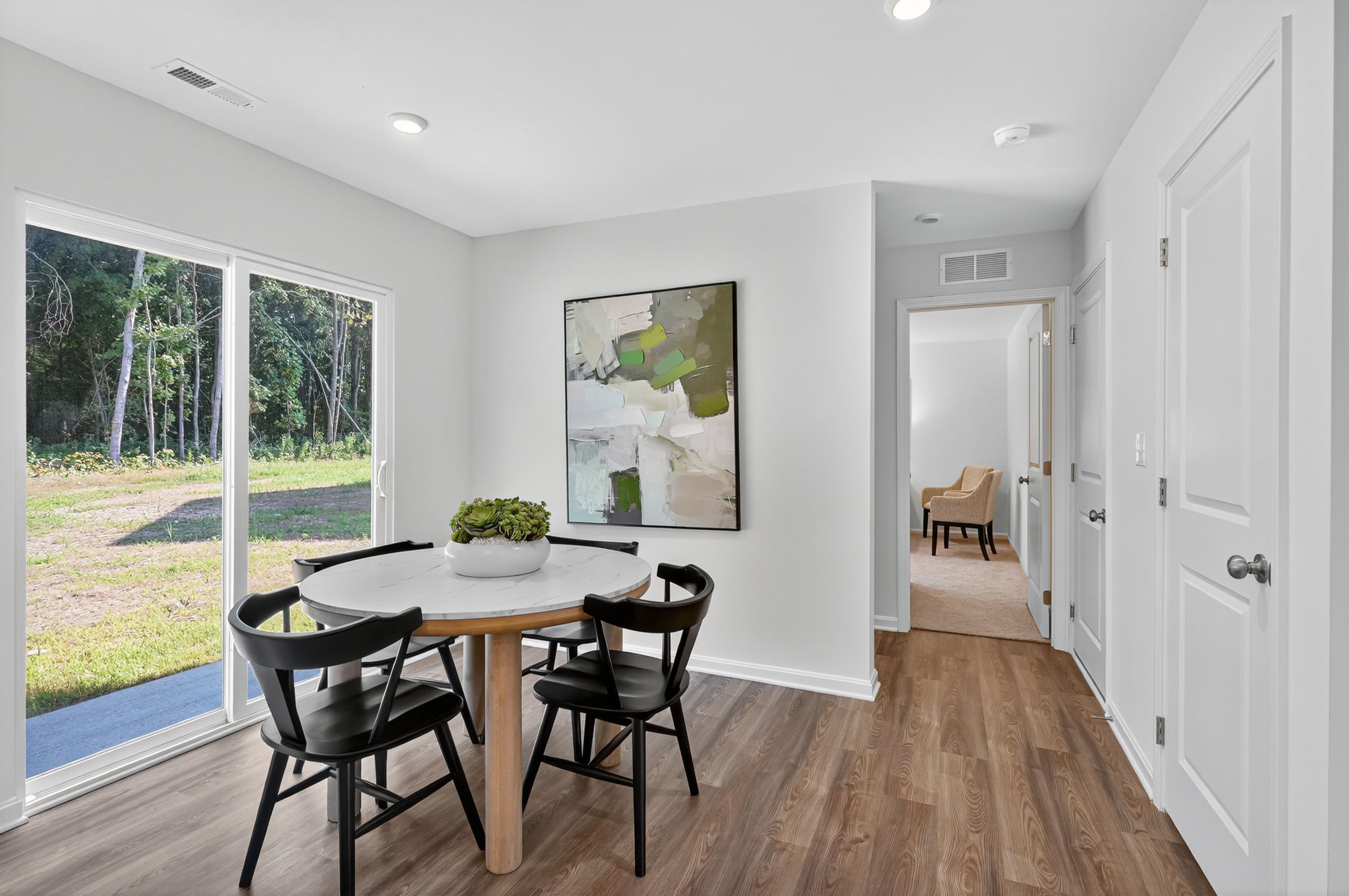 A dining room with a large glass door.