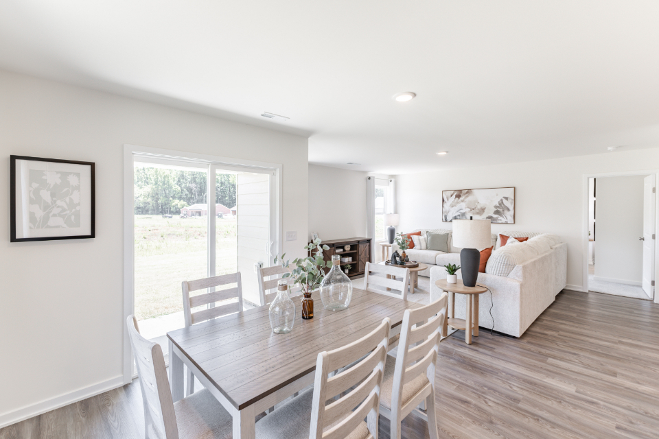 A dining room with a wood floor.