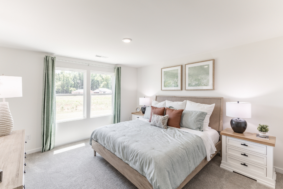 A bedroom with a bed and a window.