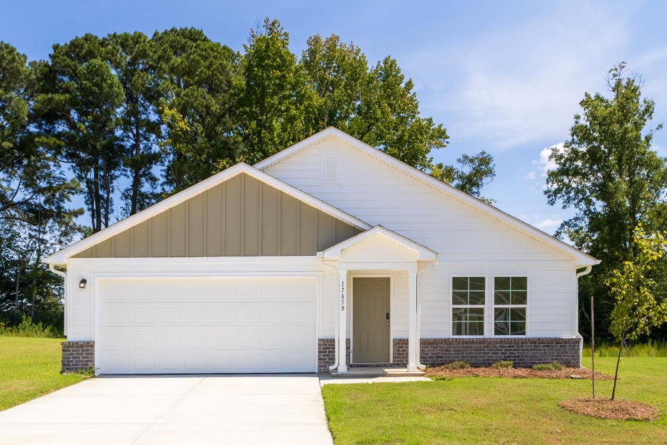 A white house with a garage.