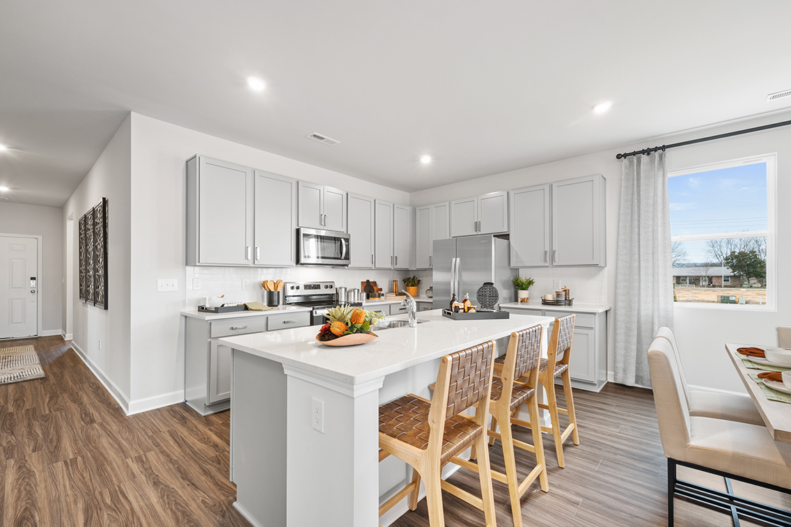 A kitchen with white cabinets.