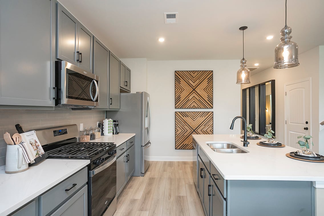 A kitchen with white cabinets.