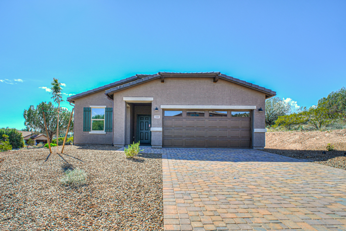A house with a brick driveway.