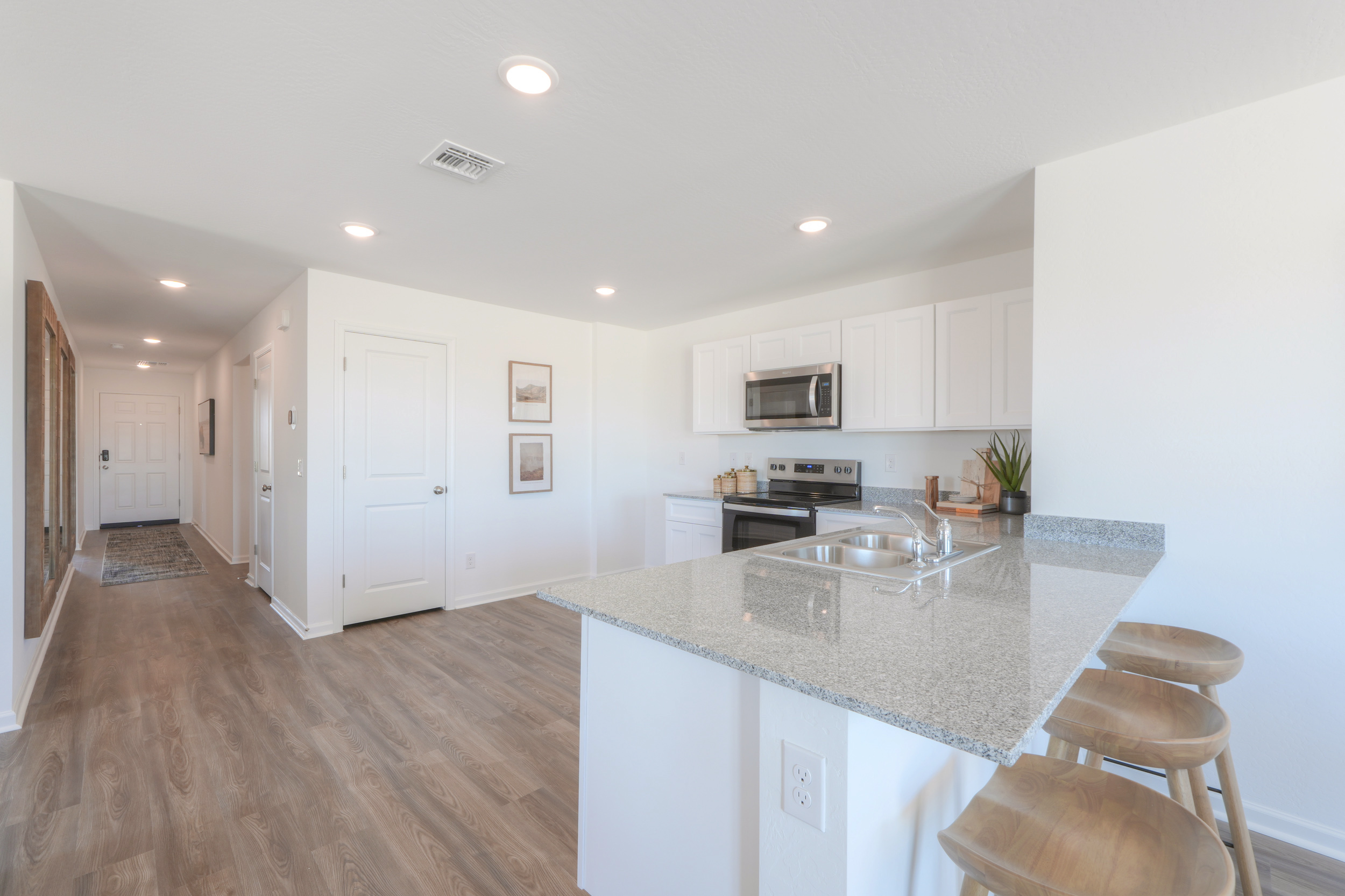 A kitchen with white cabinets.
