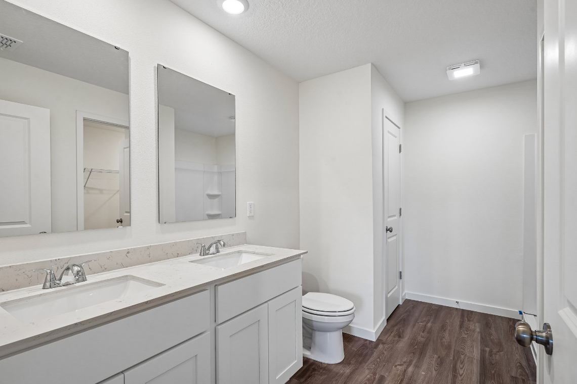 A bathroom with a toilet and sink.