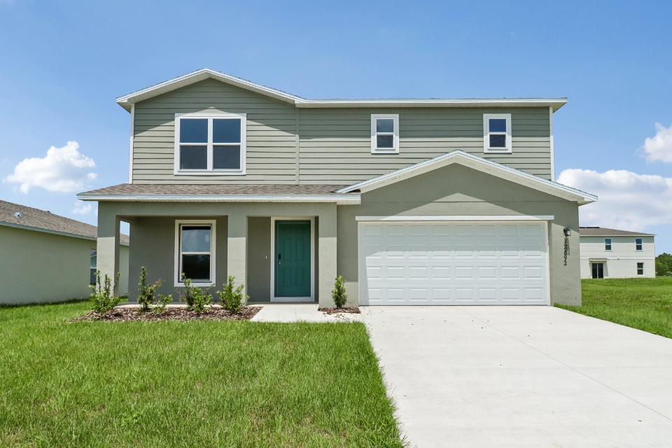 A white house with a garage.