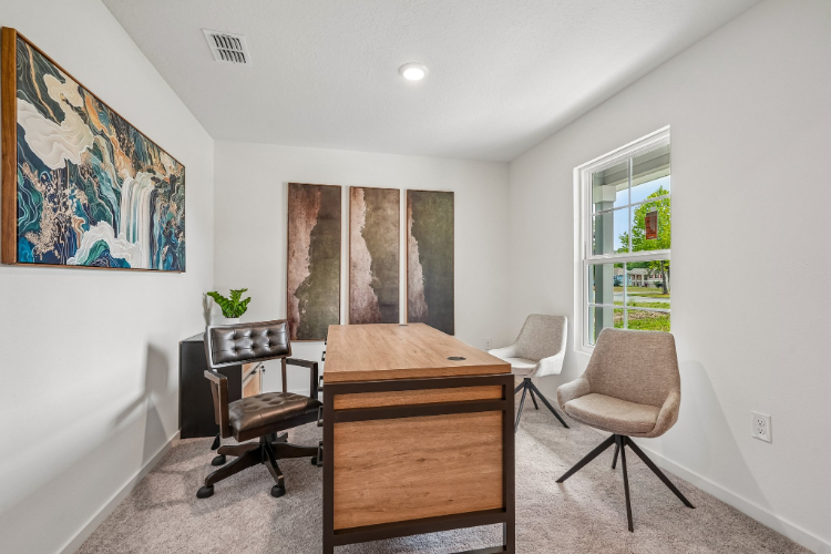 A room with a desk and chairs.