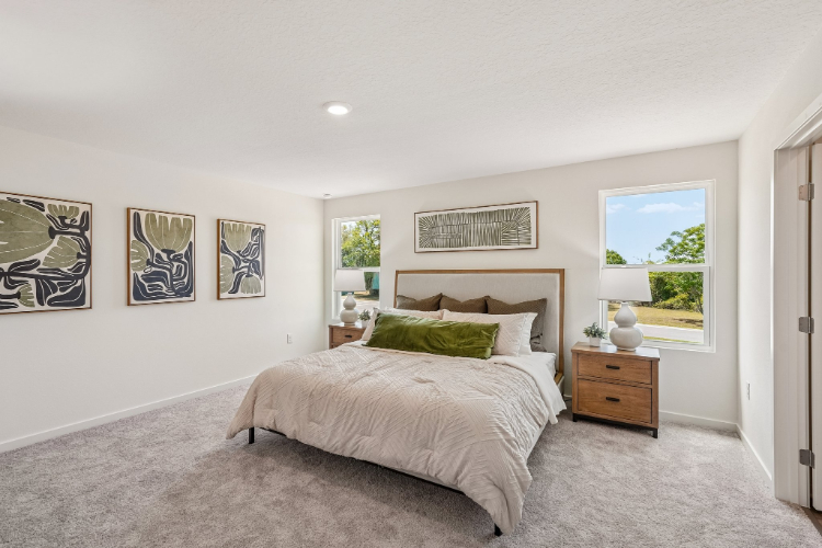 A bedroom with a bed and a window.