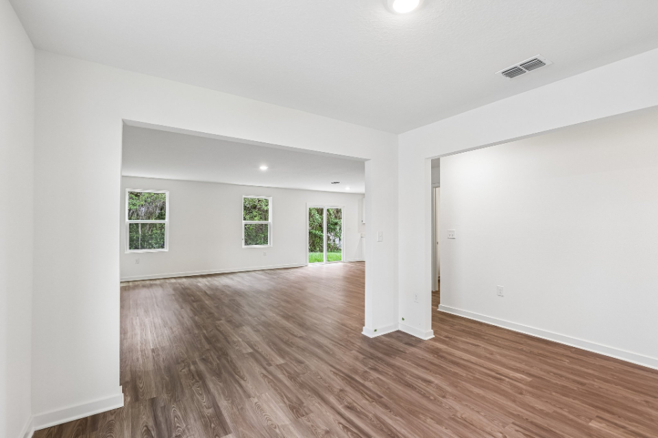 A room with a wood floor and white walls.