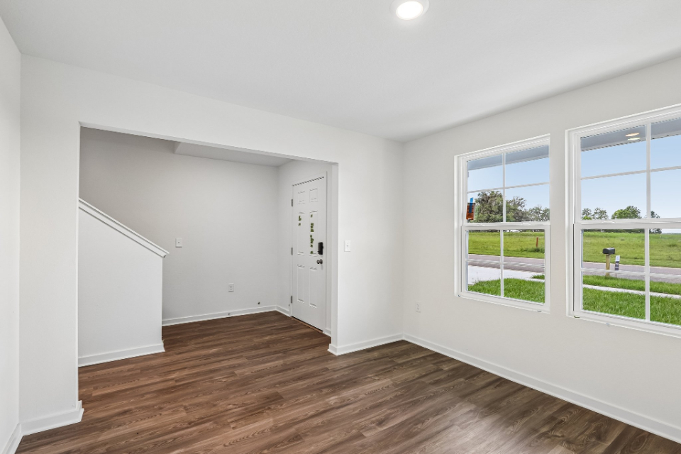 A room with windows and wood floors.