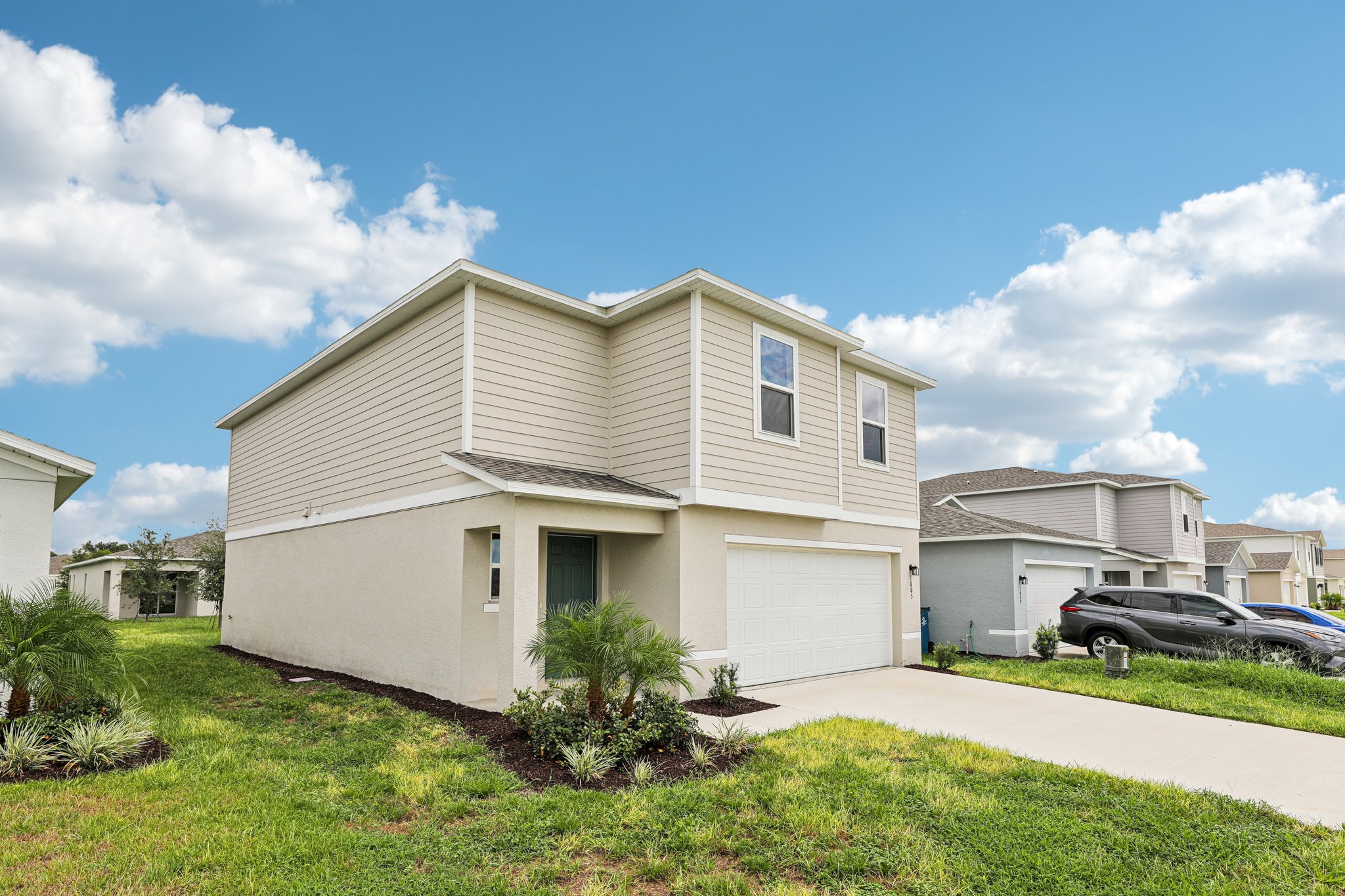 A white house with a garage.