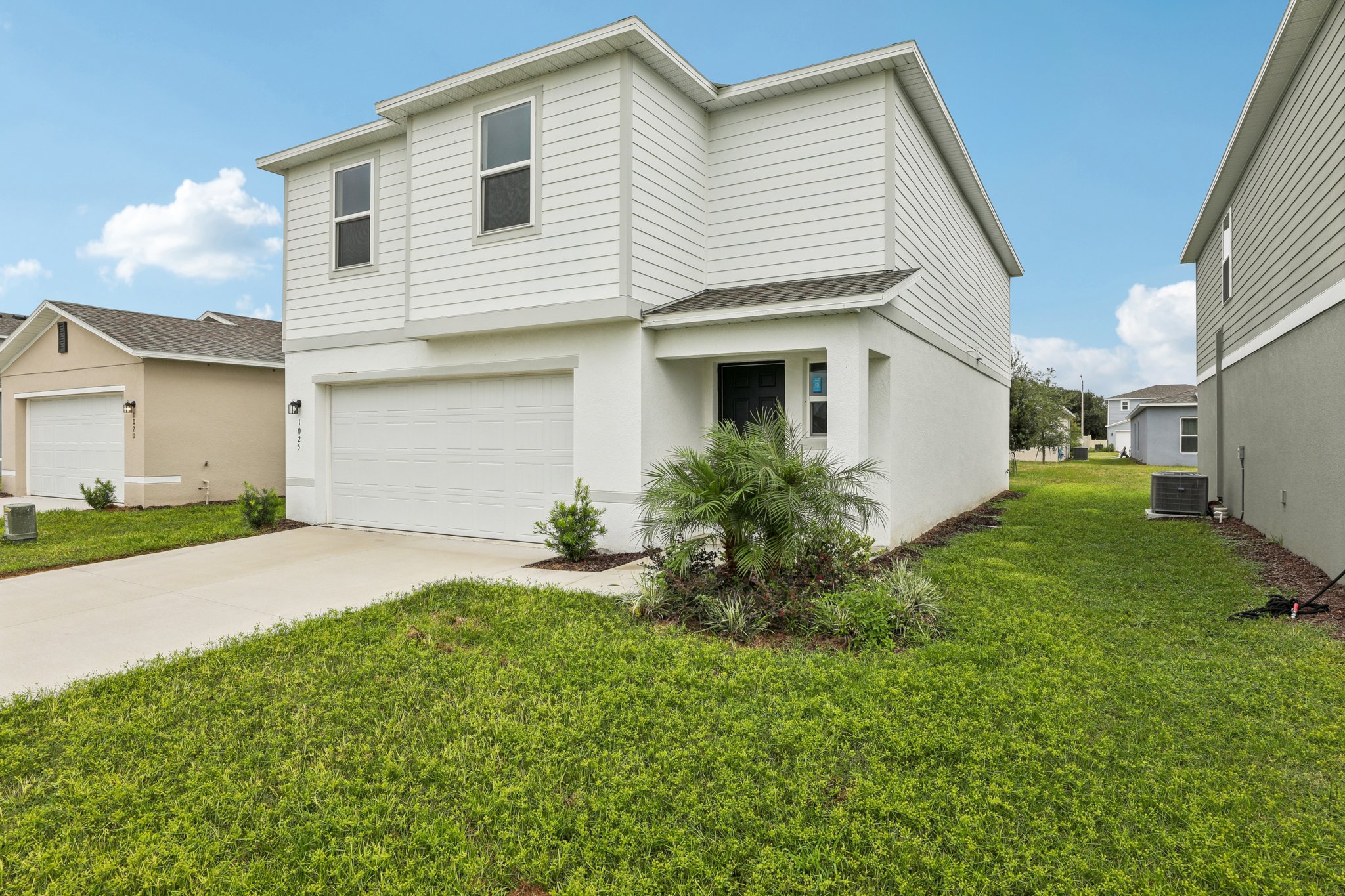 A white house with a driveway.