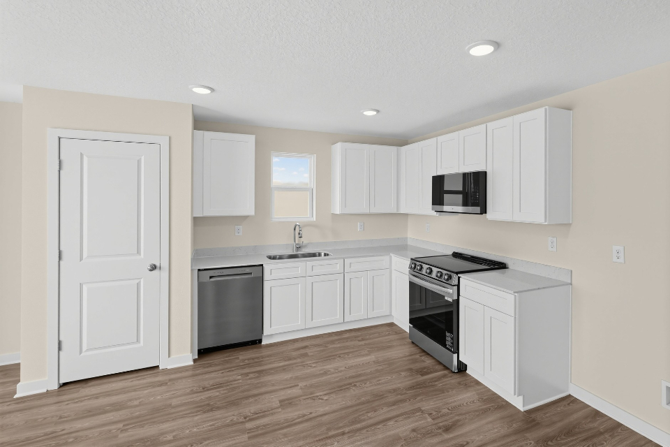 A kitchen with white cabinets.