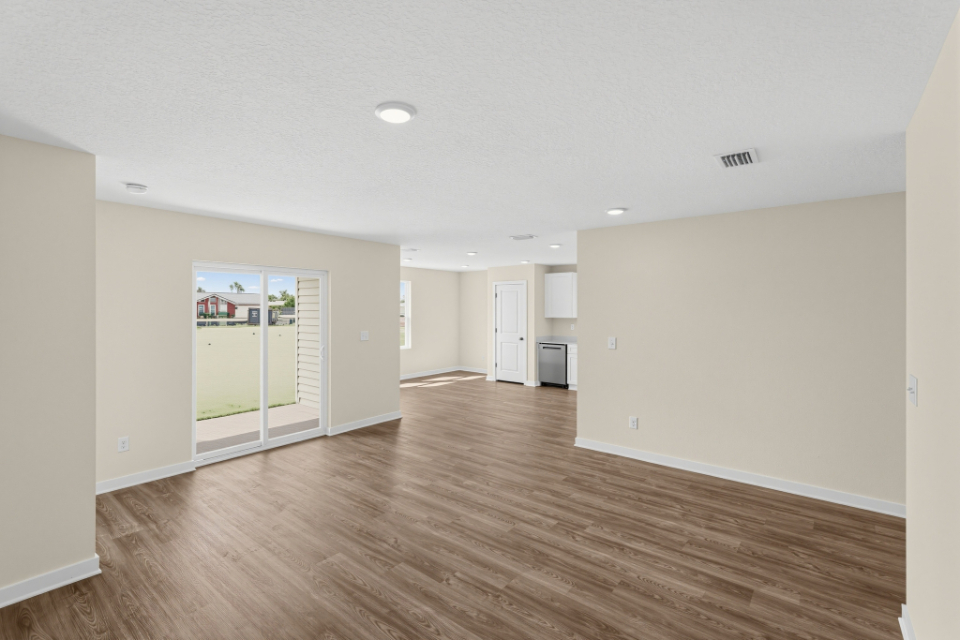 A room with a wood floor and white walls.