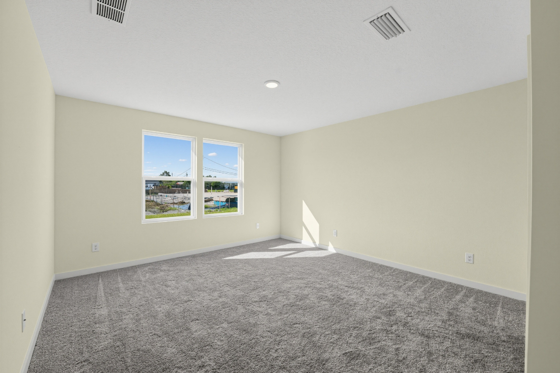 A room with a window and carpet.