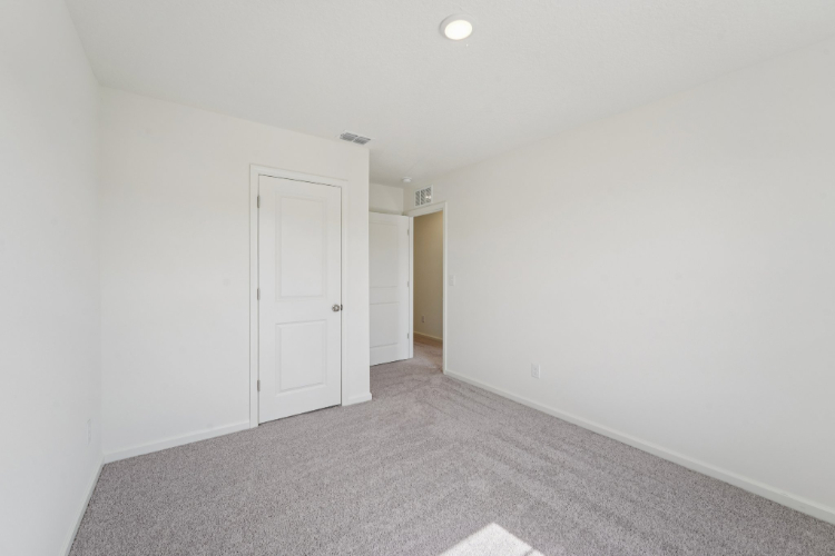 A hallway with white doors.