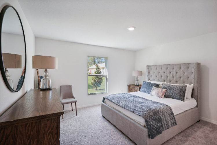 A bedroom with a bed and a desk.