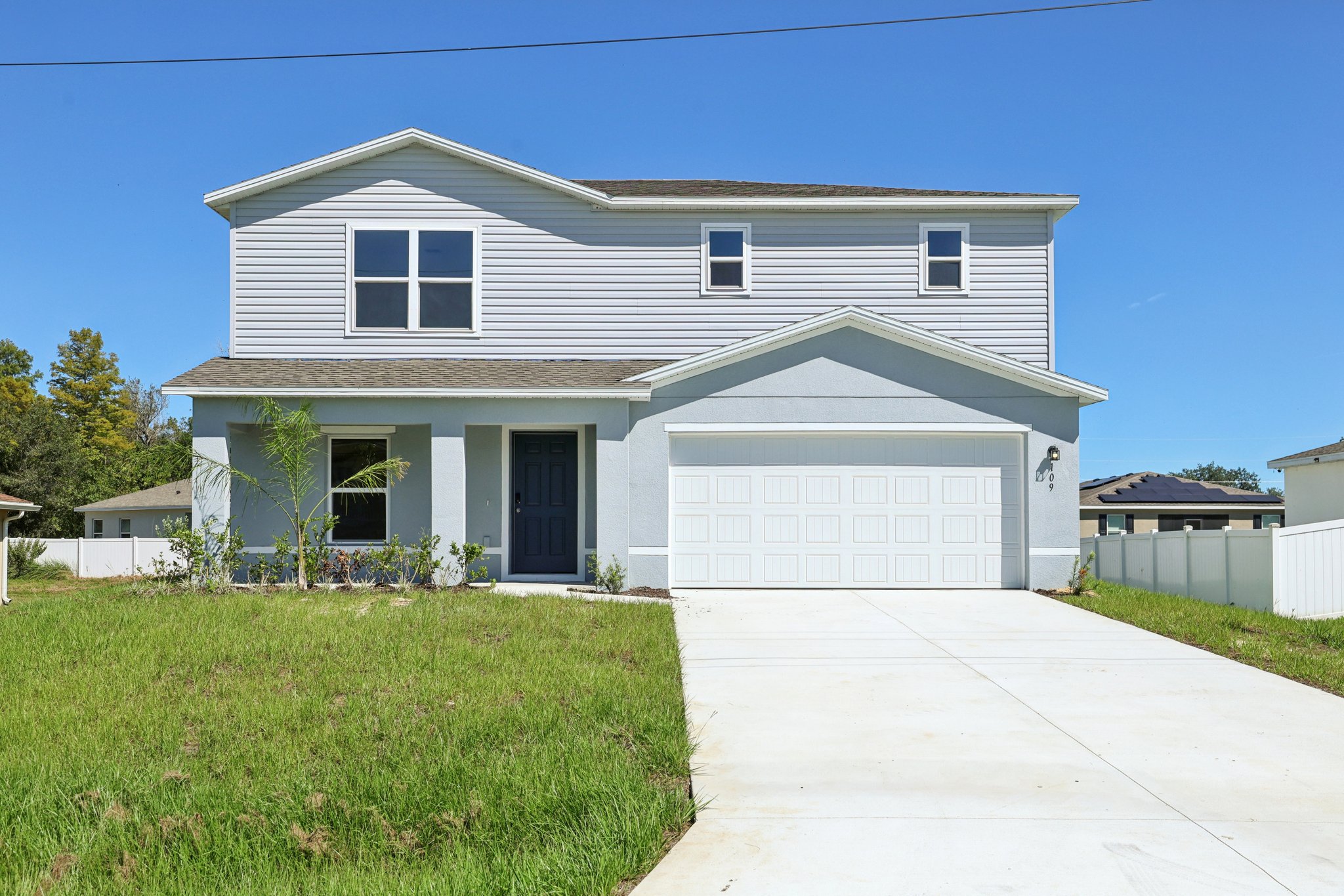 A white house with a driveway.