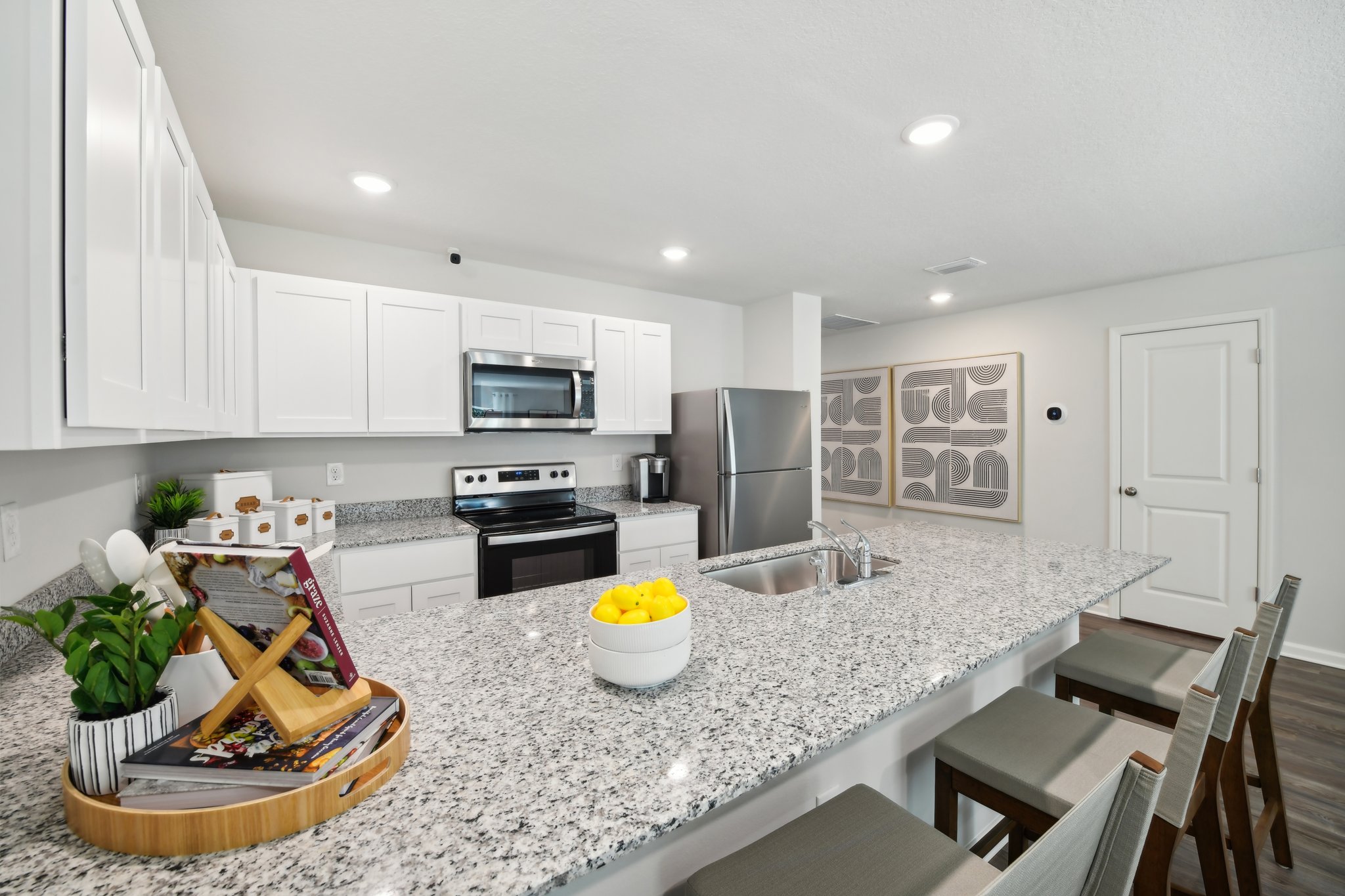 A kitchen with white cabinets.
