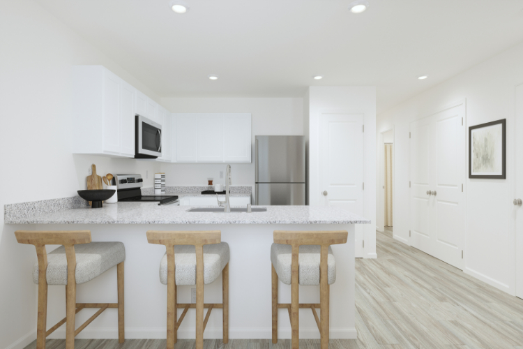 A kitchen with white cabinets.