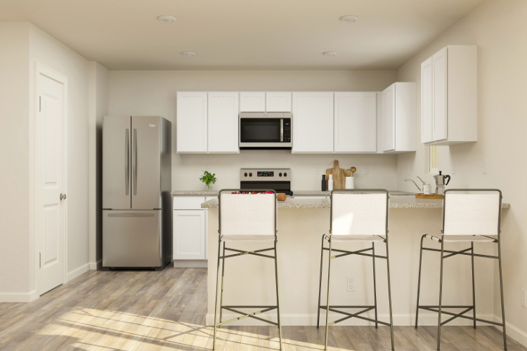 A kitchen with white cabinets.