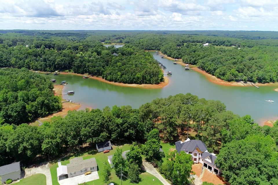 A river with trees and buildings around it.