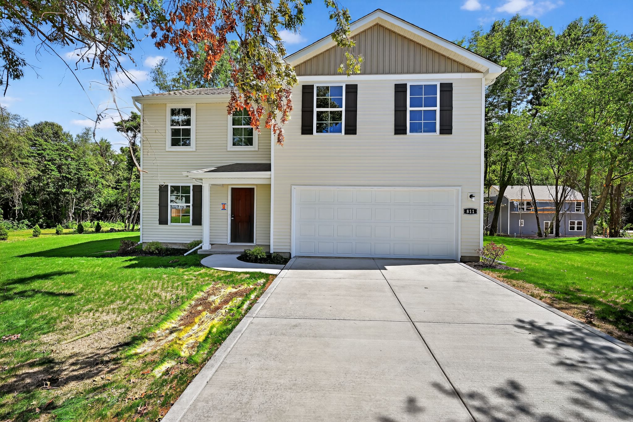 A house with a garage with Ronald Reagan Boyhood Home in the background.