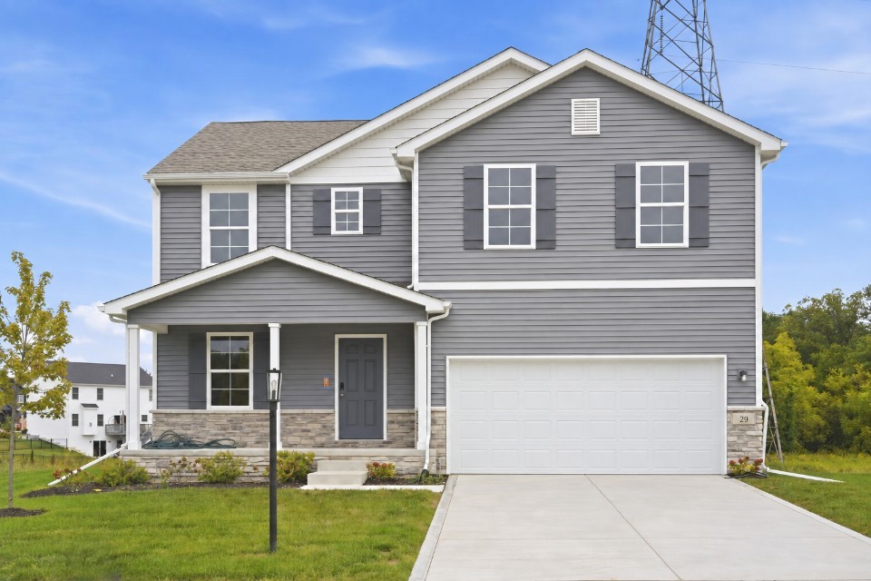 A grey house with a garage.