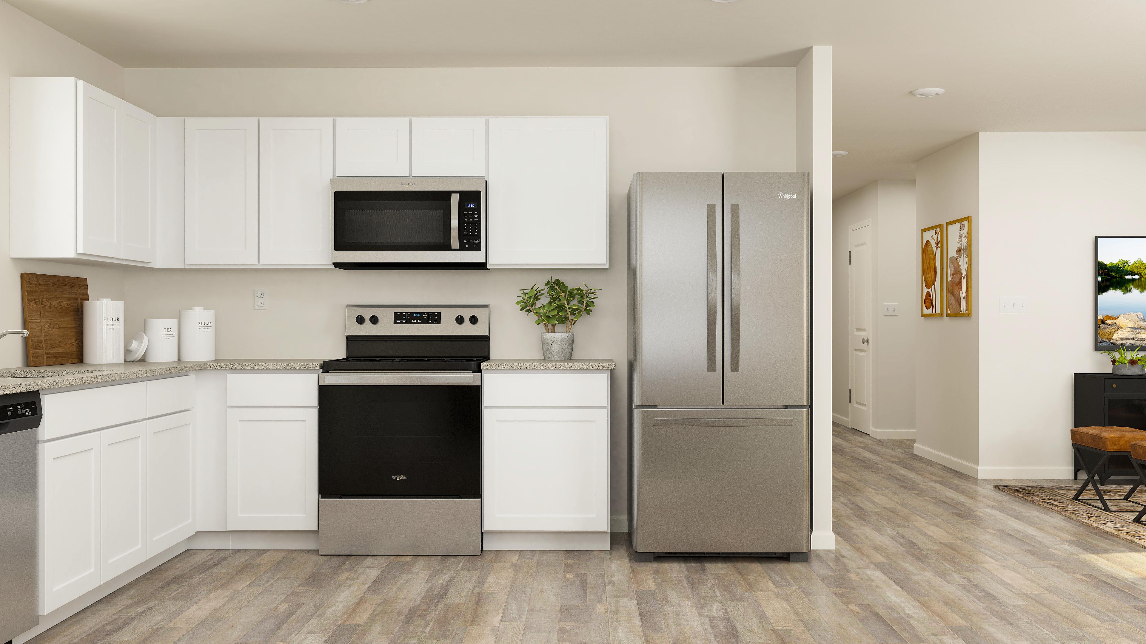 A kitchen with white cabinets.