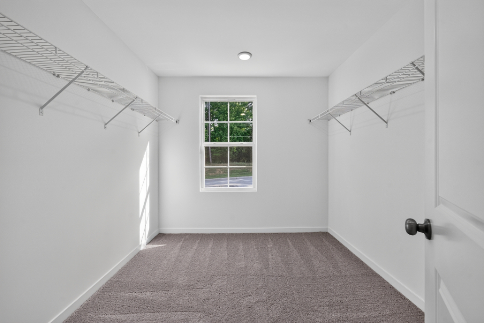 A room with white walls and a window.