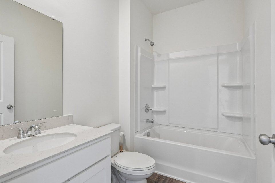 A bathroom with a sink toilet and shower.