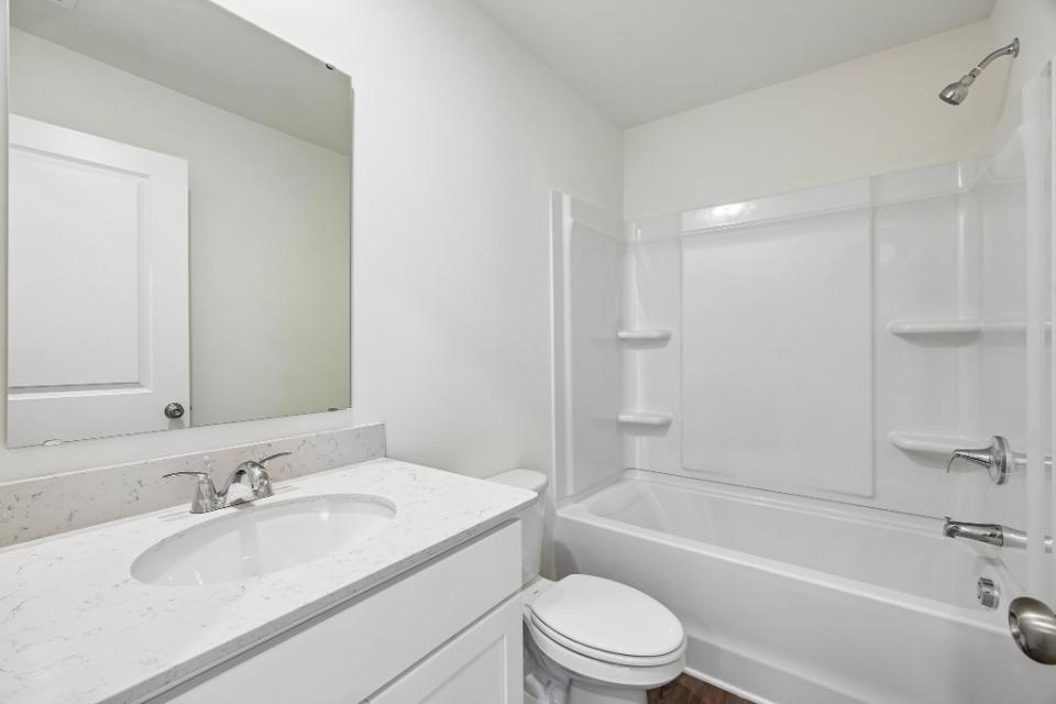 A bathroom with a sink toilet and bathtub.